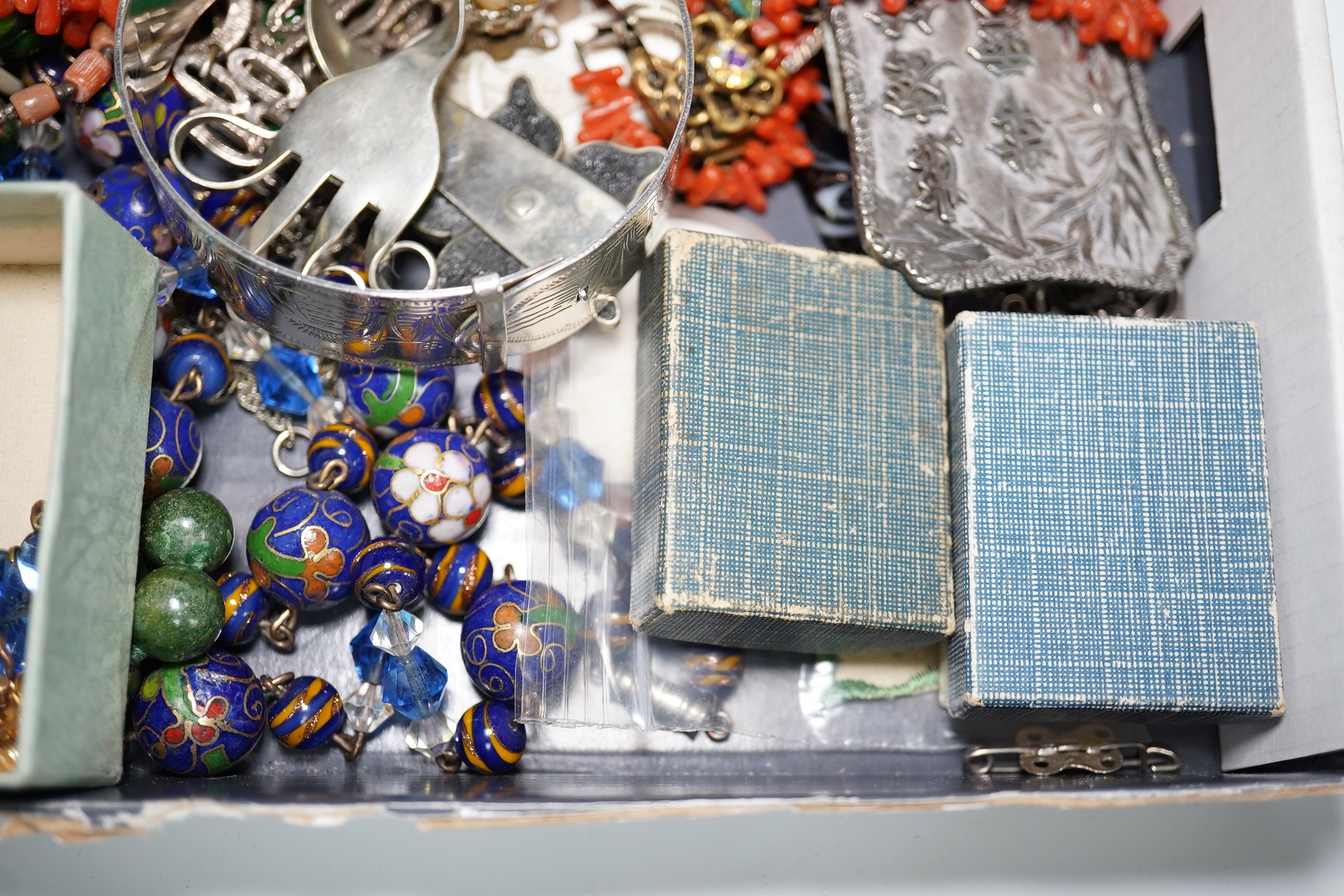 A quantity of assorted Victorian and later jewellery, including a 'Good Luck' oval locket, 9ct and garnet cluster brooch, a coral branch necklace, sterling bangle, part of a Chinese white metal buckle, Italian glass bead